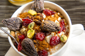 dried figs, oatmeal and orange juice breakfast setting