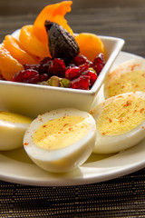 Sliced hard boiled eggs and fruit nutricious breakfast