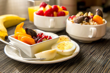 Fresh fruit and oatmeal with healthy toppings for breakfast