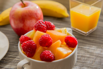 Sliced hard boiled eggs and fruit nutricious breakfast