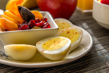 Sliced hard boiled eggs and fruit nutricious breakfast