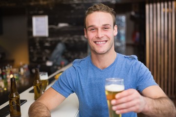Fototapeta na wymiar Young man holding pint of beer