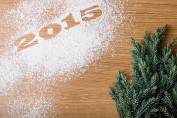 Obraz na płótnie Canvas Inscription 2015 on flour and Christmas tree on a wooden table