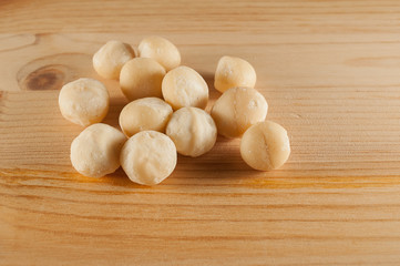 Fototapeta na wymiar Australian macadamia nut on a wood background