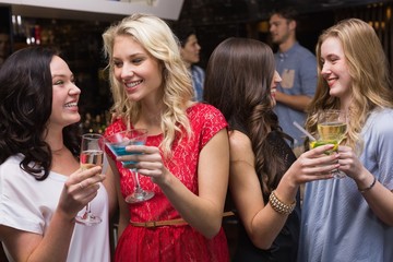 Pretty friends having a drink together