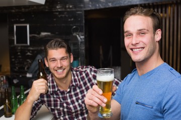 Young men drinking beer together