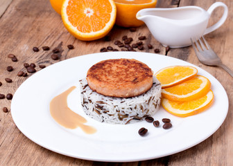 Salmon medallion with mixed cooked rice on white plate