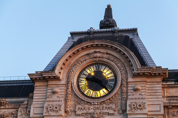Ancient clock on the wall of Orsay Museum in Paris