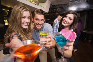 Happy friends having a drink together