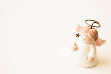 Porcelain angel on gray background with star
