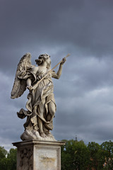 Fototapeta na wymiar Angel statue in Rome Italy against cloudy sky