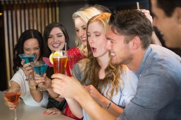 Young friends having a drink together