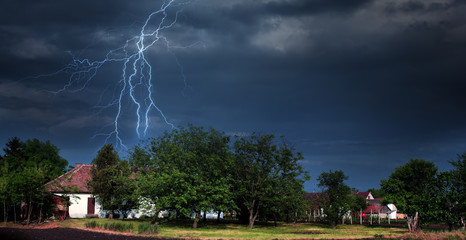 Lightning storm over village