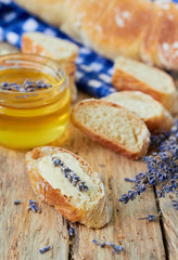 Bread and jar of honey with lavender flowers
