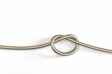 a single knot in a flexible metal hose