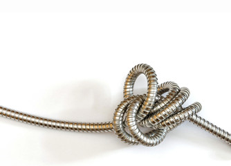 an intricate knot formed by a flexible metal hose