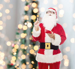 man in costume of santa claus with notepad