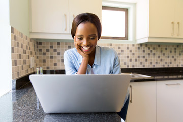 african woman browsing internet on laptop