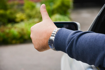 Hand sign OK from a car window