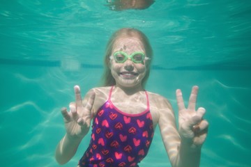 Cute kid posing underwater in pool