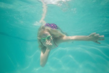 Cute kid posing underwater in pool