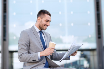 young businessman with coffee and newspaper