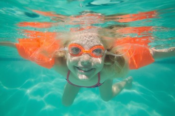 Cute kid posing underwater in pool