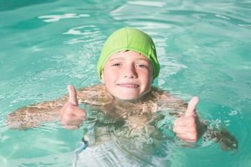 Cute kid swimming in the pool