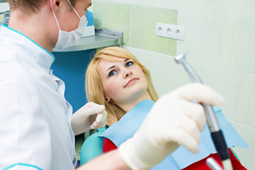 Fototapeta premium Happy smiling female patient dentist office ready for procedure