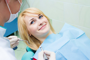 Happy smiling female patient dentist office ready for procedure