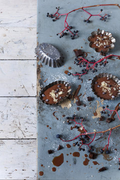 chocolate pastries on vintage molds on table with branches