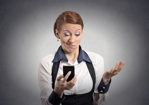 displeased woman reading bad news on smartphone