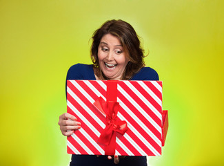 Portrait happy excited middle aged woman opening red gift box