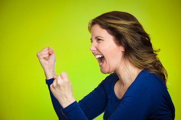 Side profile angry woman screaming on green background 