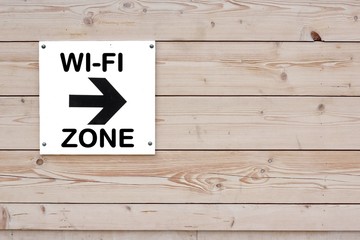 Pointer with Arrow and sign WI-FI ZONE on Wood Wall