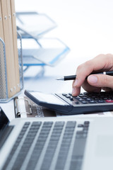 Businessman analyzing investment charts with laptop. Accounting