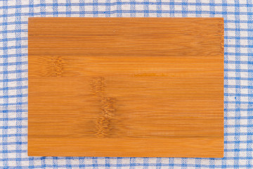wood cutting board on tablecloth