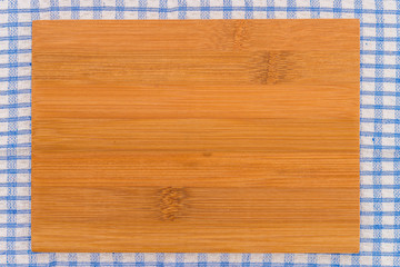 wood cutting board on tablecloth