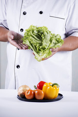Chef holds lettuce