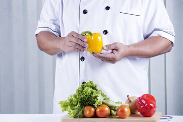 Chef holds bell pepper