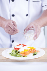 Chief puting salad dressing