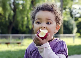 Fotobehang Child eating apple © Pavla Zakova