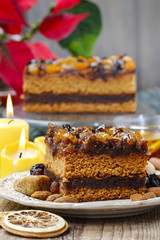 Delicious layer gingerbread cake decorated with dried fruits