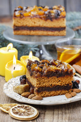 Delicious layer gingerbread cake decorated with dried fruits