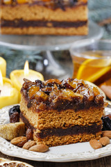 Delicious layer gingerbread cake decorated with dried fruits
