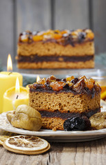 Delicious layer gingerbread cake decorated with dried fruits