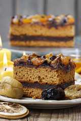 Delicious layer gingerbread cake decorated with dried fruits