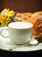 Continental breakfast with cappuccino and croissant
