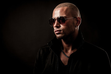Dark photos of a mysteryous handsome young man with sunglasses