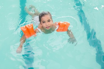 Cute little girl learning to swim